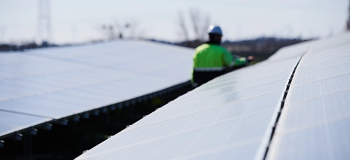 Solar panels; a man walking in the background (photo)