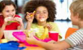 Children eating from colorful containers (photo)
